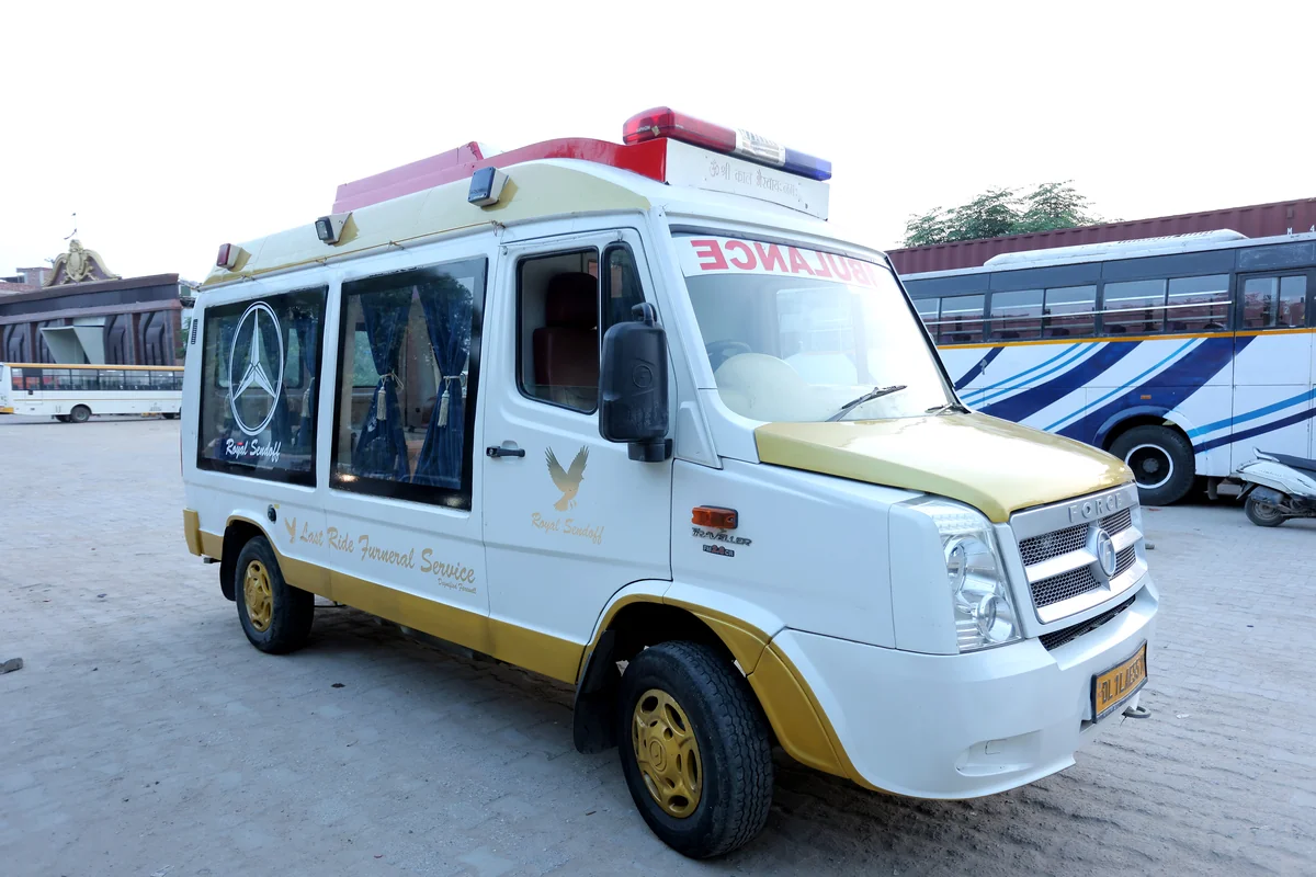Side profile of Last Ride Funeral premium AC Force Traveller glass hearse van with yellow trim, Mercedes star emblem and Royal Sendoff luxury fit-out — Delhi NCR fleet